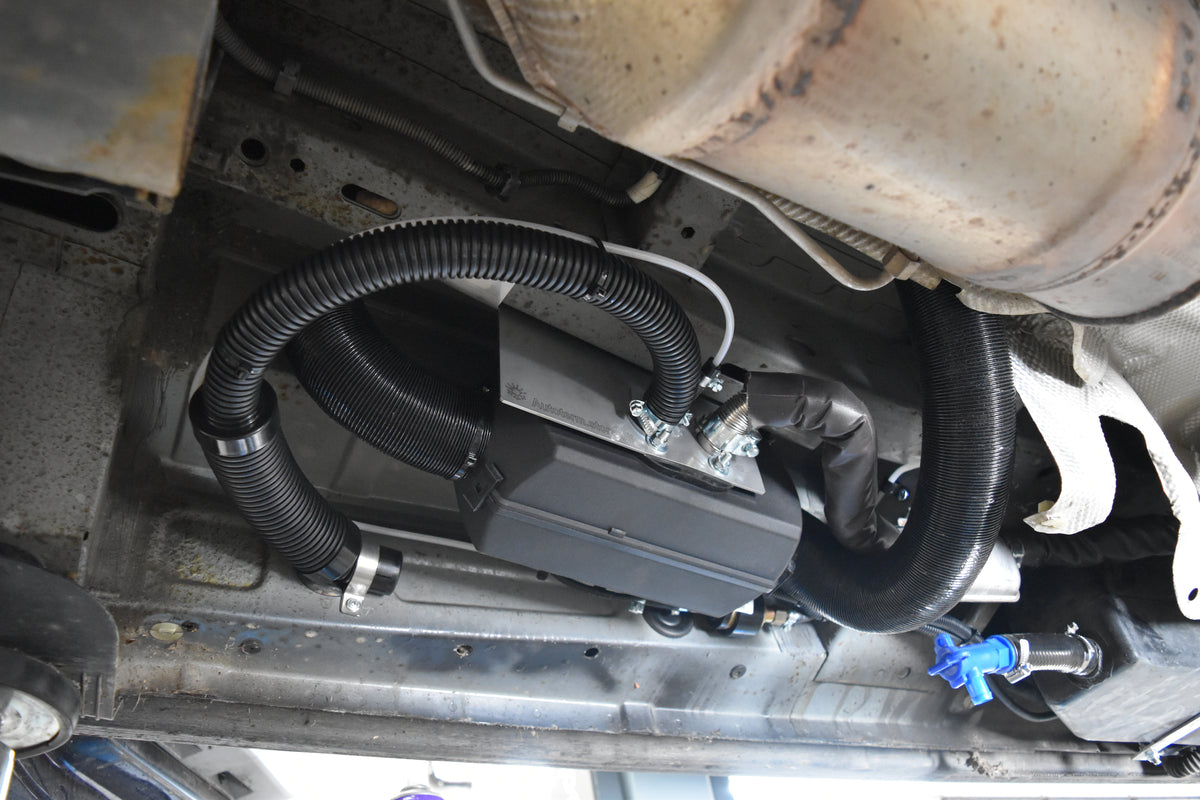 Close-up of a car's undercarriage with visible diesel heater fitted underslung