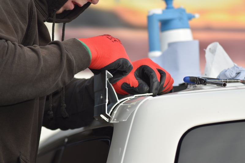 Person working on measuring up a bracket to fit an awning 