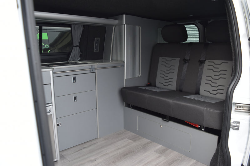 Van interior with grey seats and storage compartments