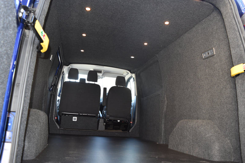 Ford Transit Custom with grey carpeting on the walls and black sparkle flooring