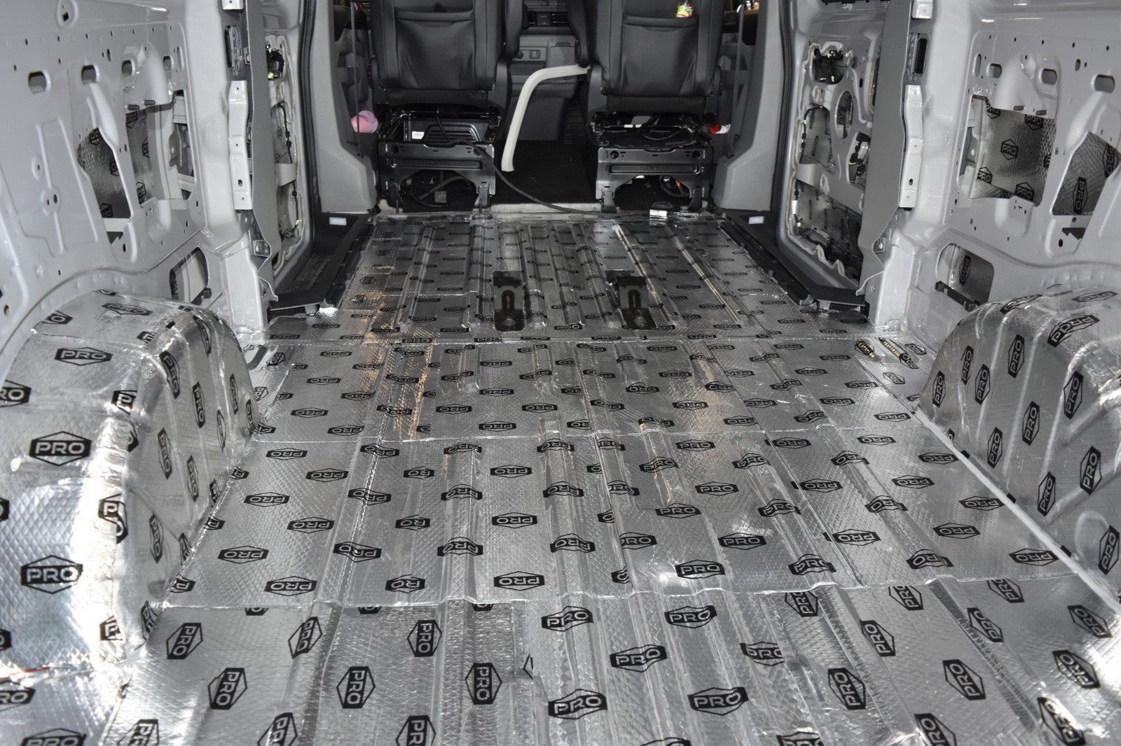Van interior with sound deadening fitted to floor, wheel arches, sides and roof 