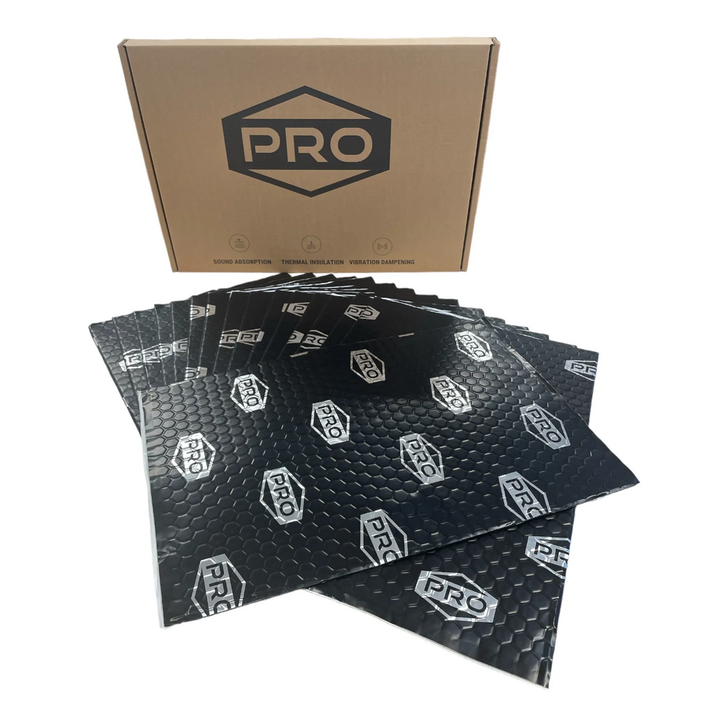 Stack of black PRO branded sound deadening sheets with a cardboard box in the background