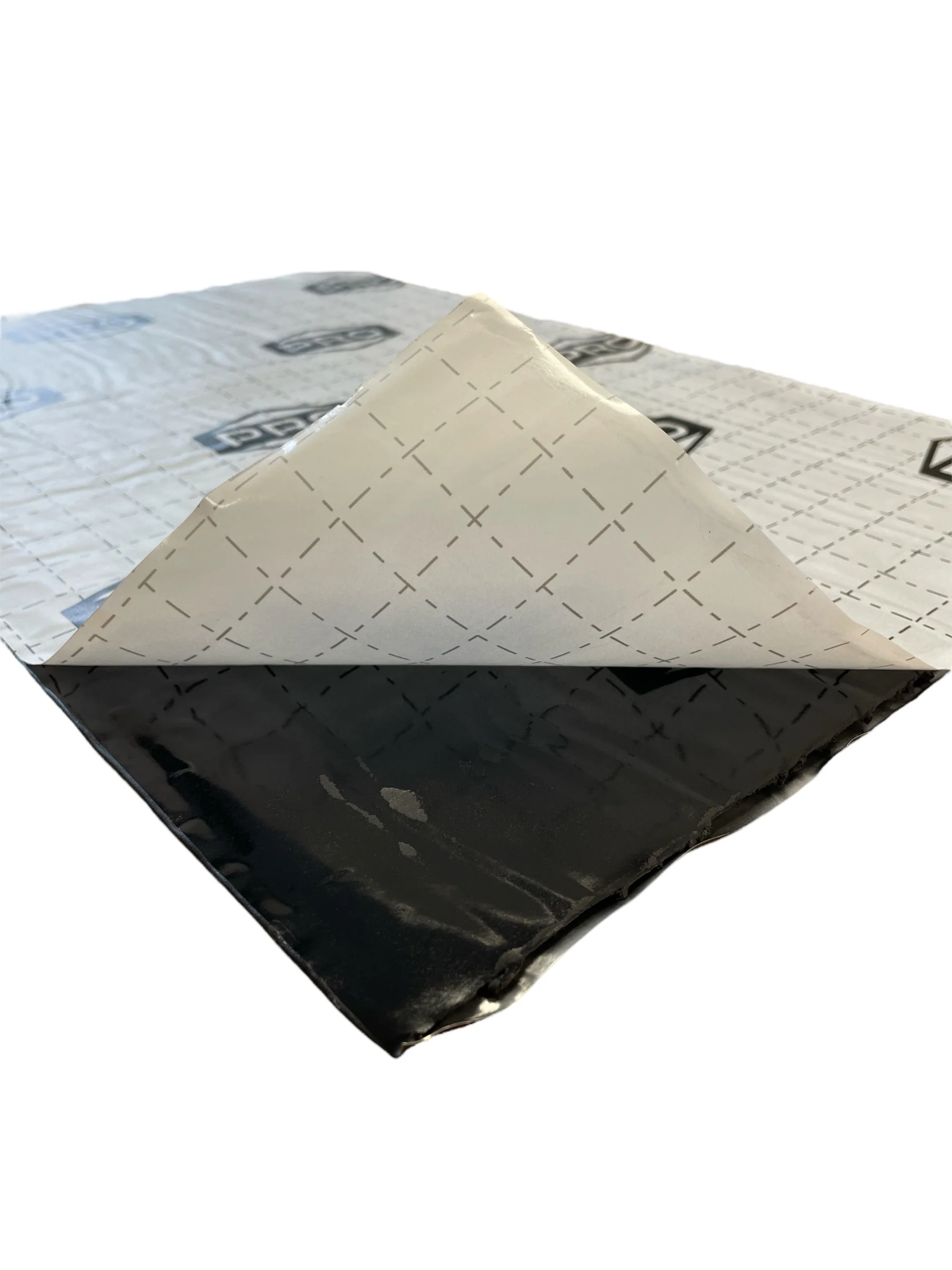 Close up of a Pro deadening sound deadening sheet with backing peeled slightly 