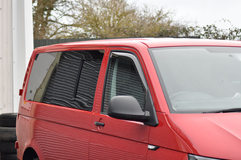 Red VW Transporter T6 with side windows fitted, including an opening window