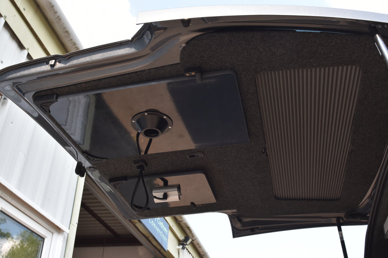 Open ca boot with a table top mounted on the bottom of the door. 