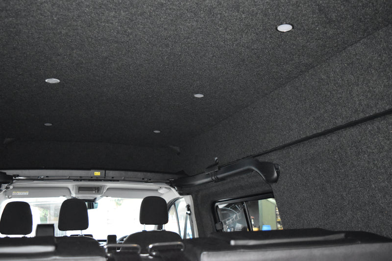Car interior with black carpeted ceiling and seats