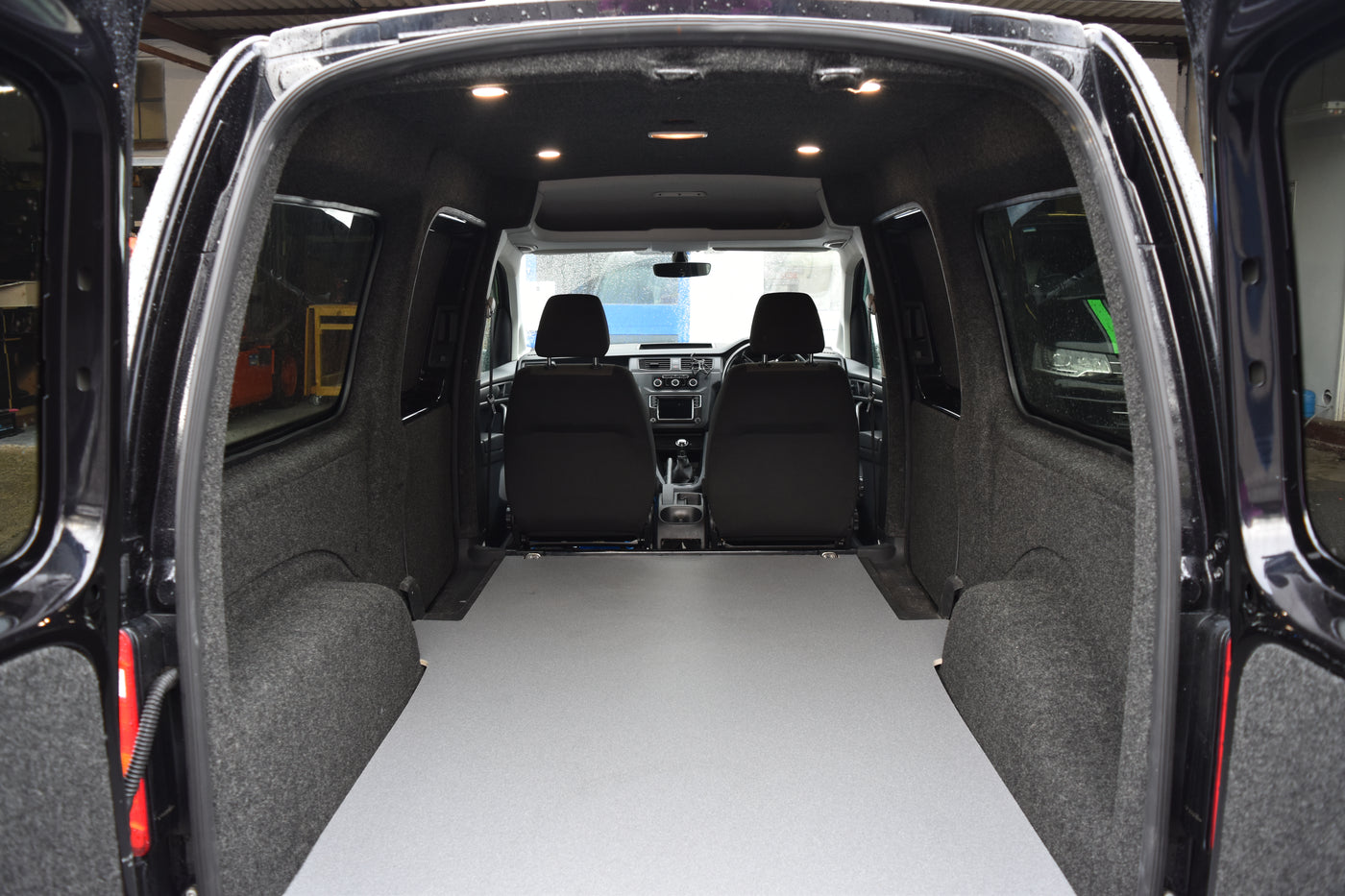Interior of a Caddy Maxi carpet lined, with ply boarding, LED spot lights and floor covering