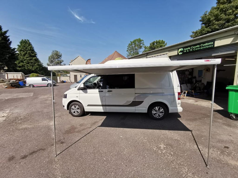 White VW Transporter with awning opened on side
