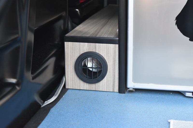 VW Transporter camper van with diesel heater outlet behind front seats, fitted in a box