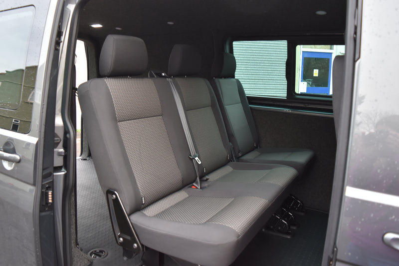 Grey interior of a van with seats.