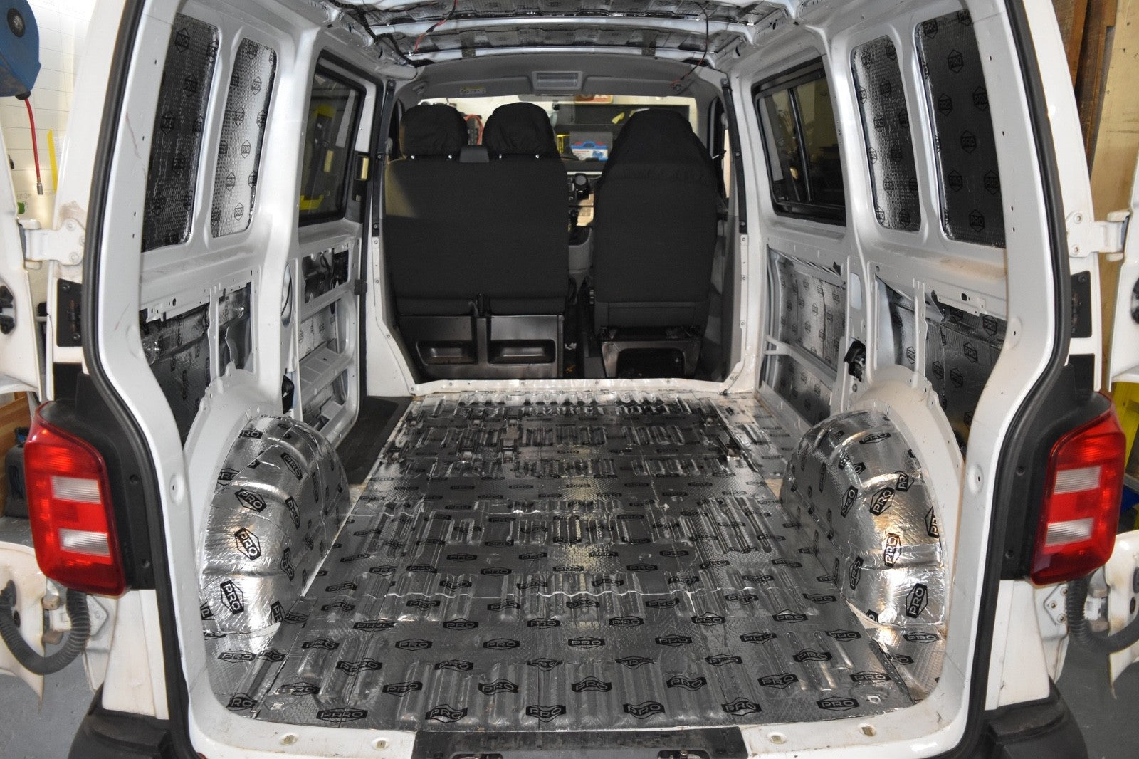 Back of VW Transporter van with sound deadening fitted to the floor, wheel arches, walls and roof