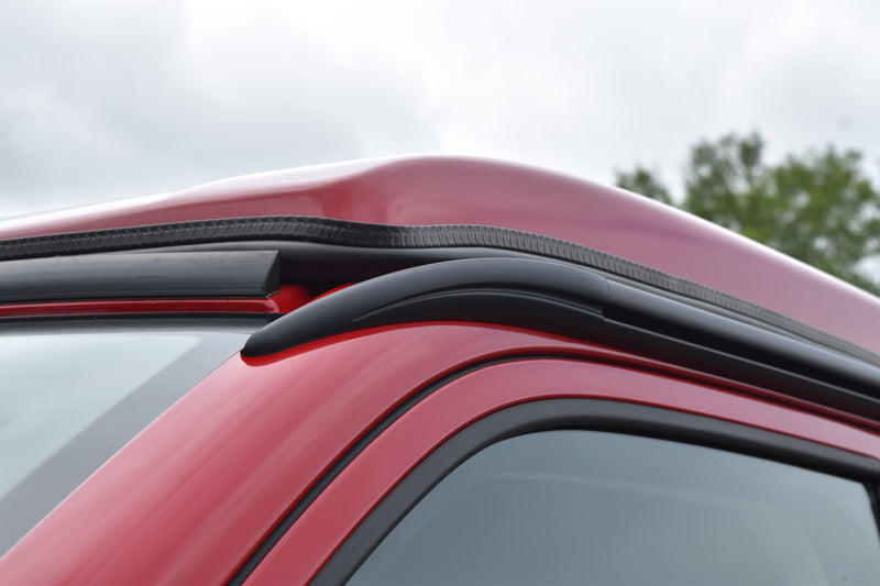 Red VW Transporter with awning rail end cap showing