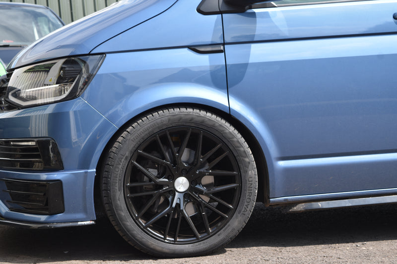 Close-up of a blue car with black alloy wheel