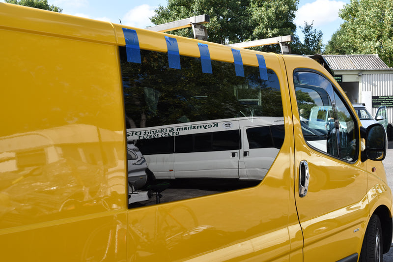 Yellow Vivaro with a fixed window fitted