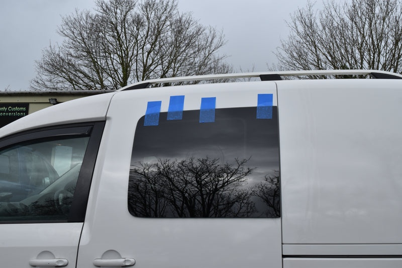 White Caddy van with side fixed window fitted