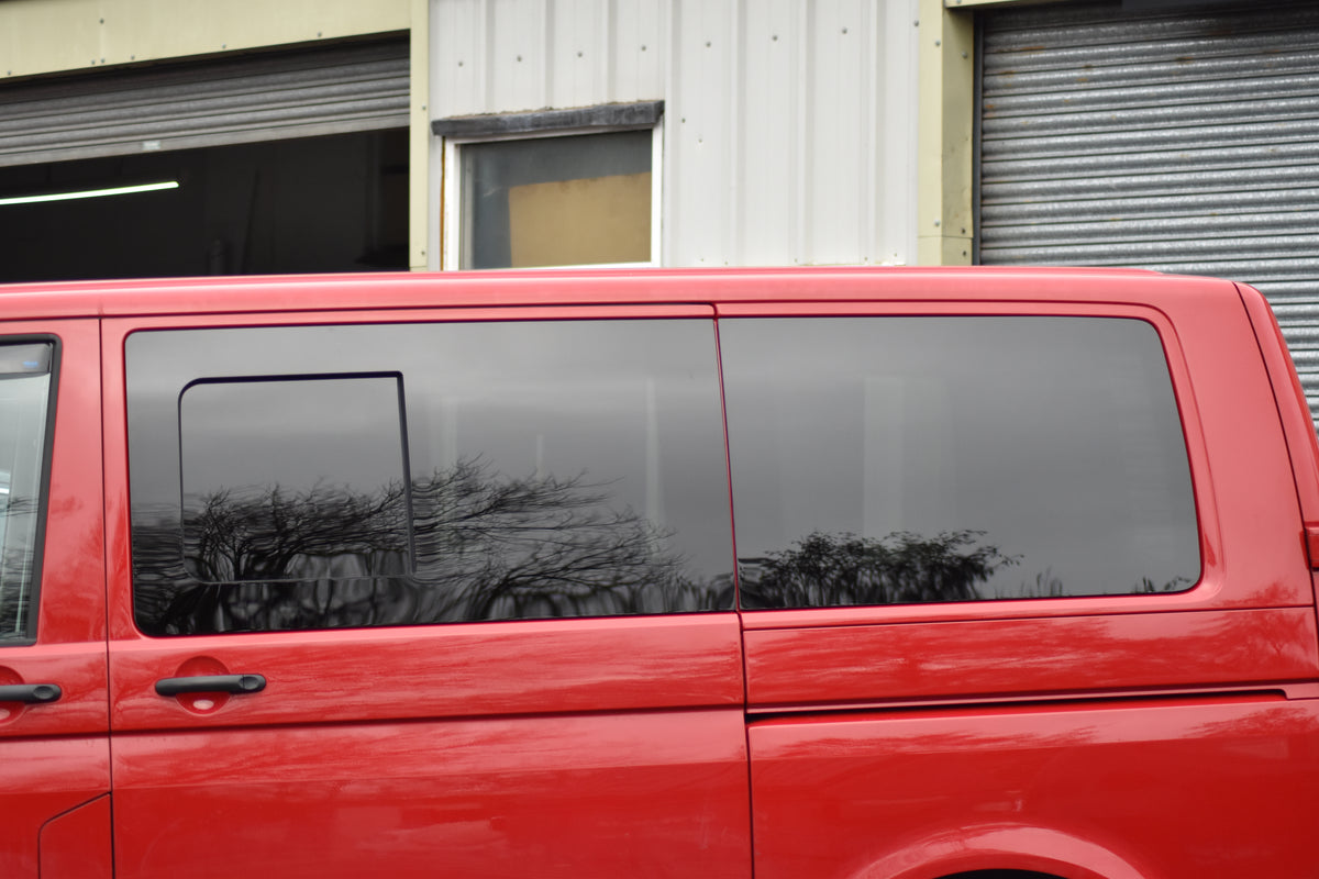 Red Transporter van with both side windows fitted